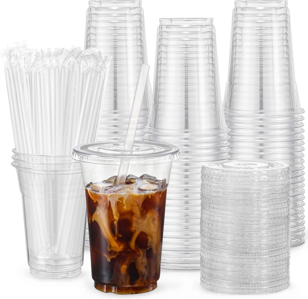 Bright reusable drink cups with lids and straws at an outdoor party.