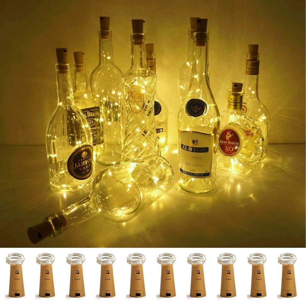 Wine bottle filled with glowing LED string lights on a garden table