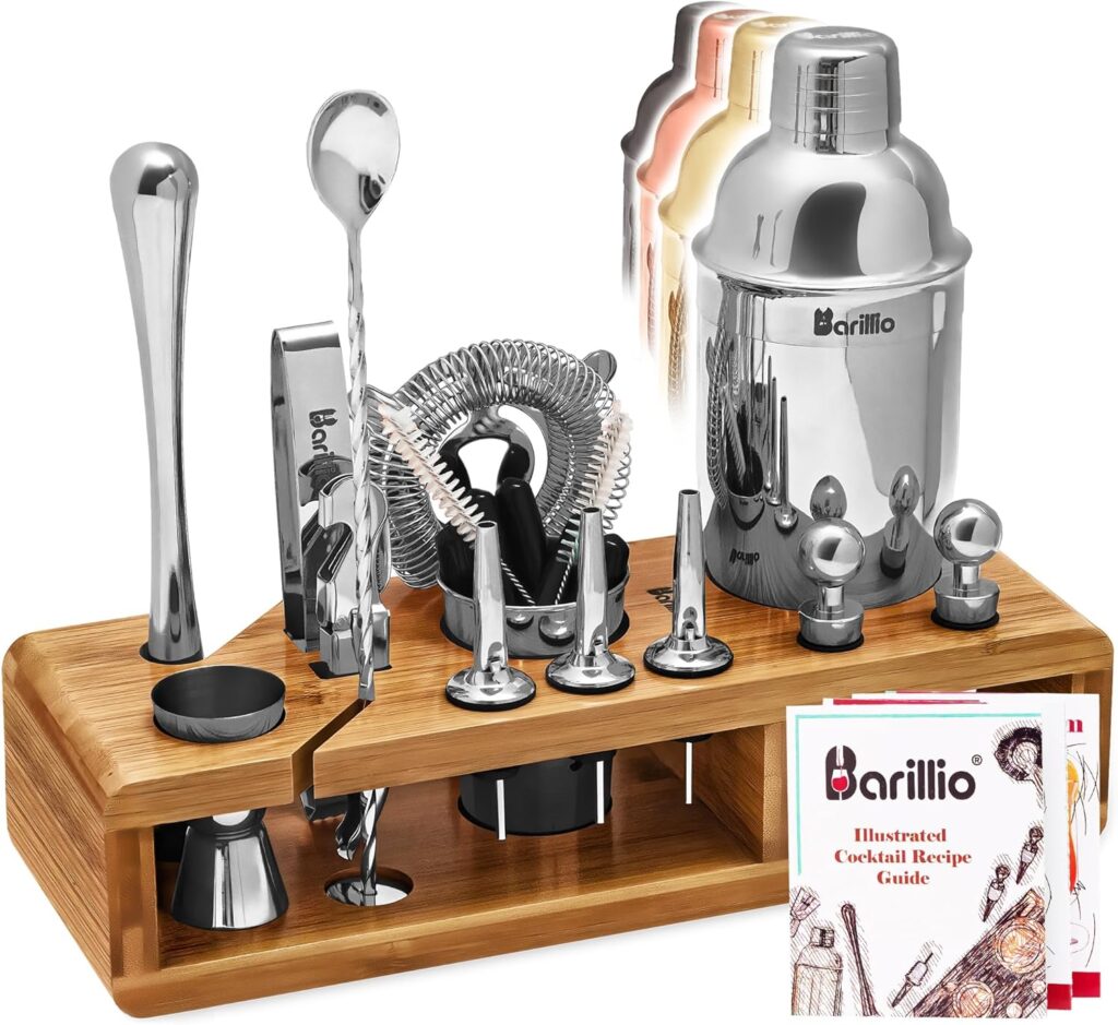 Outdoor cocktail kit set up on a picnic blanket with mixers and tools.