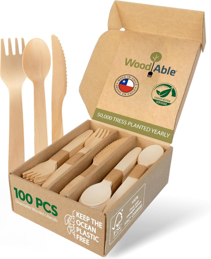 Eco-friendly bamboo cutlery arranged neatly beside picnic plates.