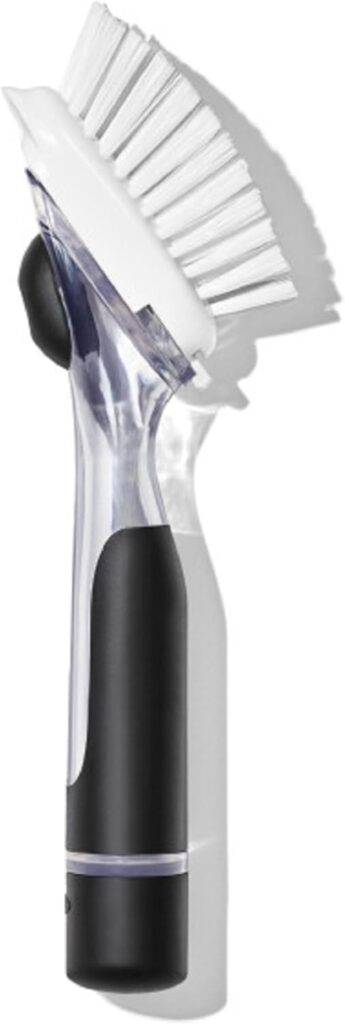 Soap dispensing dishwashing brush with built-in reservoir and scrubbing head